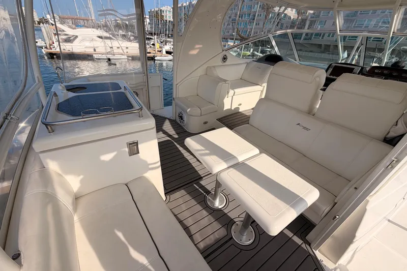 Slide: The Image of 2005 Cruisers Yachts 405 Express Motoryacht interior with white seating and marina view. - 27