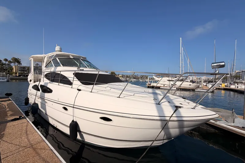 Slide: The Image of 2005 Cruisers Yachts 405 Express Motoryacht docked in a marina under clear blue skies. - 1