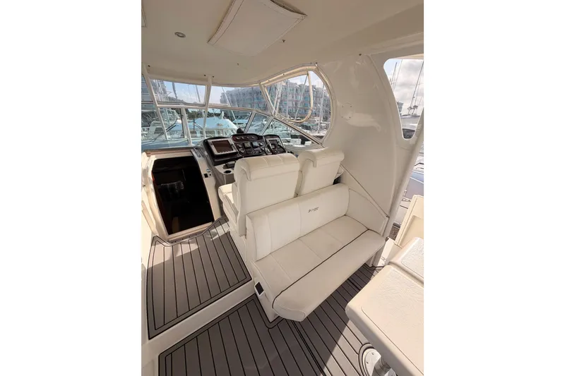 Slide: The Image of 2005 Cruisers Yachts 405 Express Motoryacht cockpit with white seating and navigation controls. - 30