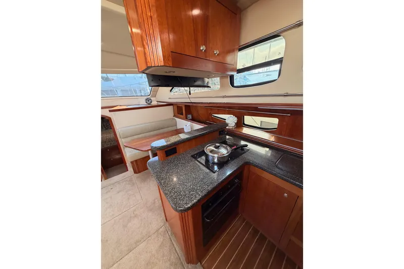 Slide: The Image of Luxurious 2005 Cruisers Yachts 405 Express Motoryacht interior kitchen with modern amenities. - 47