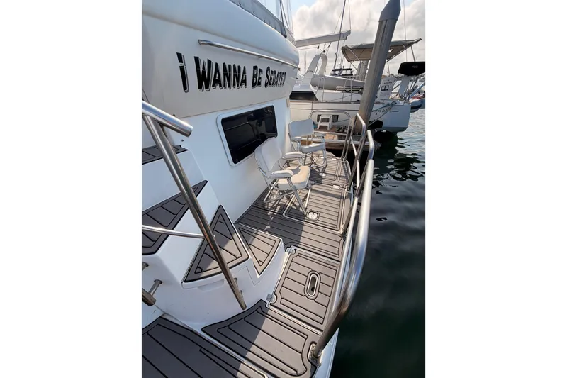 Slide: The Image of 2005 Cruisers Yachts 405 Express Motoryacht docked with seating on deck. - 9