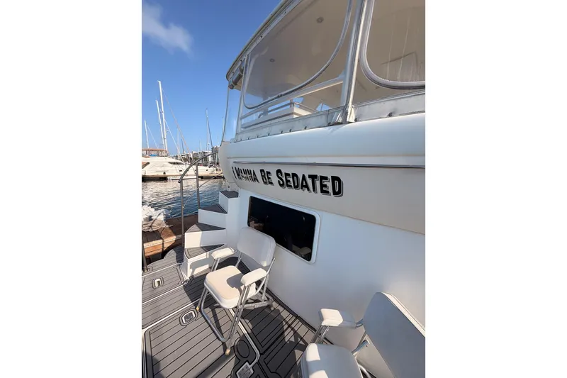 Slide: The Image of 2005 Cruisers Yachts 405 Express Motoryacht docked with seating area. - 12