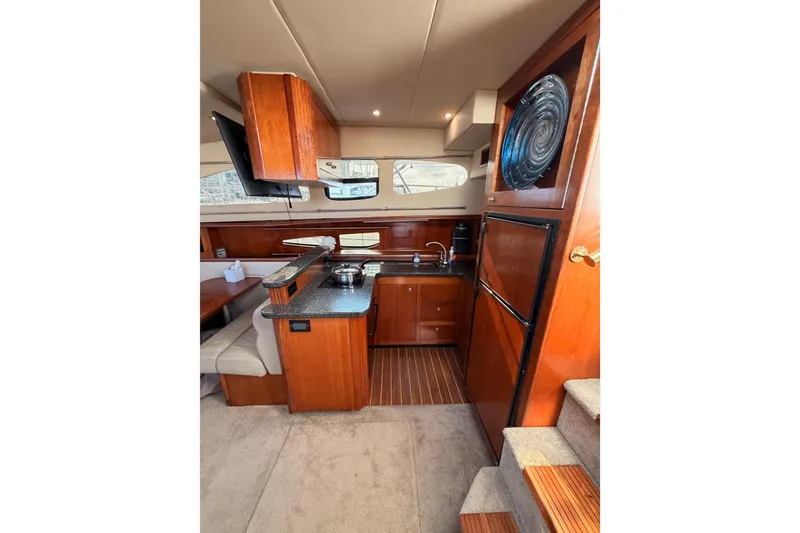 Slide: The Image of Luxurious 2005 Cruisers Yachts 405 Express Motoryacht interior with modern kitchen amenities. - 42