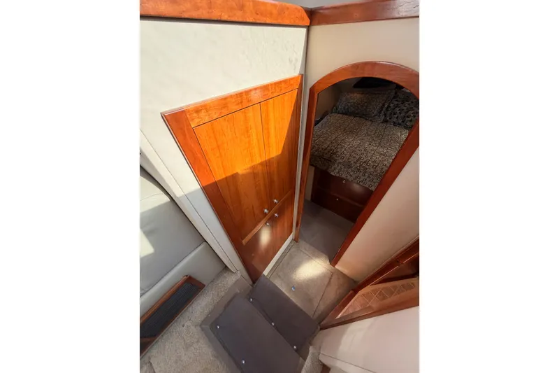 Slide: The Image of Interior view of 2005 Cruisers Yachts 405 Express Motoryacht, featuring wooden doors and cozy cabin. - 52