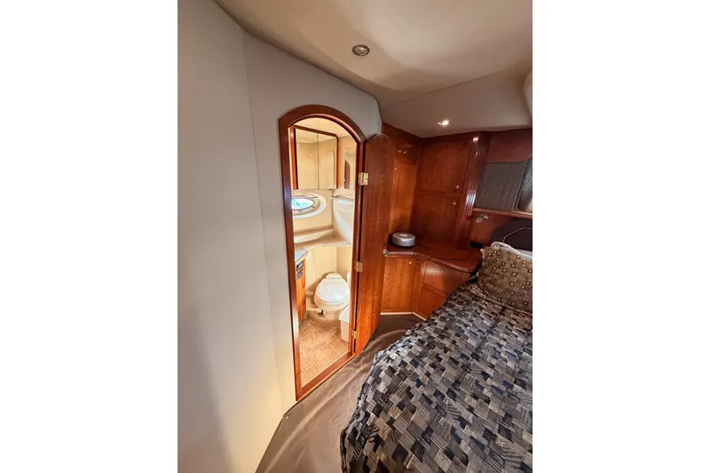 Slide: The Image of Luxurious 2005 Cruisers Yachts 405 Express Motoryacht interior with bedroom and bathroom view. - 81