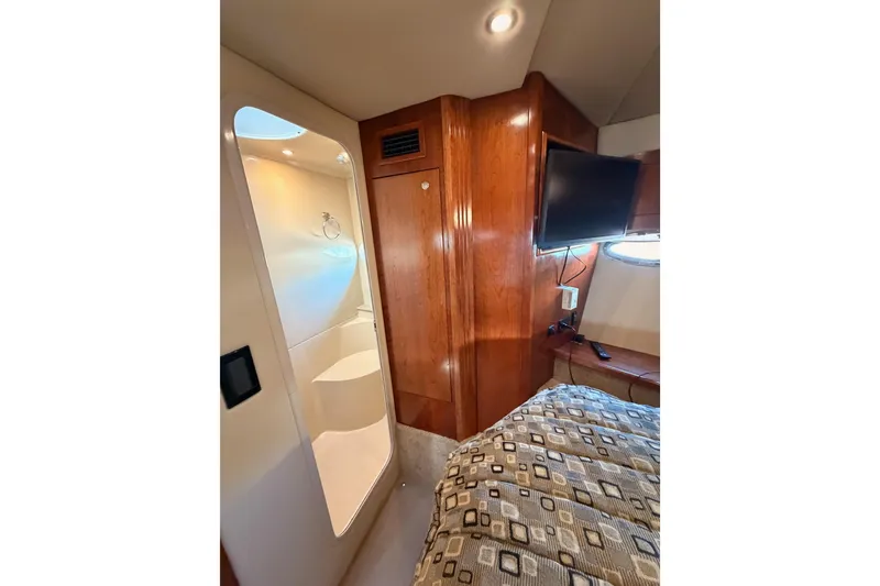 Slide: The Image of Luxurious 2005 Cruisers Yachts 405 Express Motoryacht interior with wood paneling and modern amenities. - 64