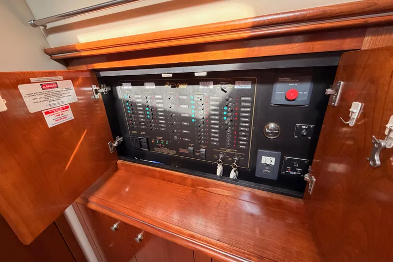 Slide: The Image of Electrical panel inside 2005 Cruisers Yachts 405 Express Motoryacht, featuring switches and controls. - 73