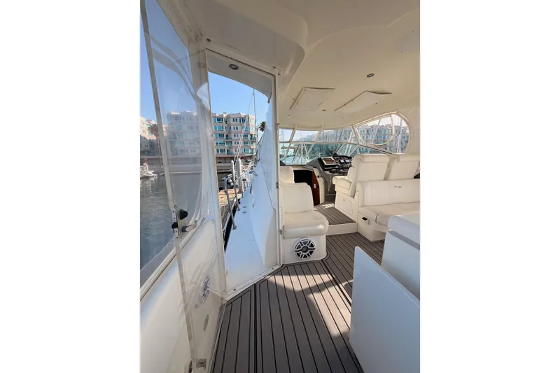 Slide: The Image of 2005 Cruisers Yachts 405 Express Motoryacht interior with white seating and marina view. - 15