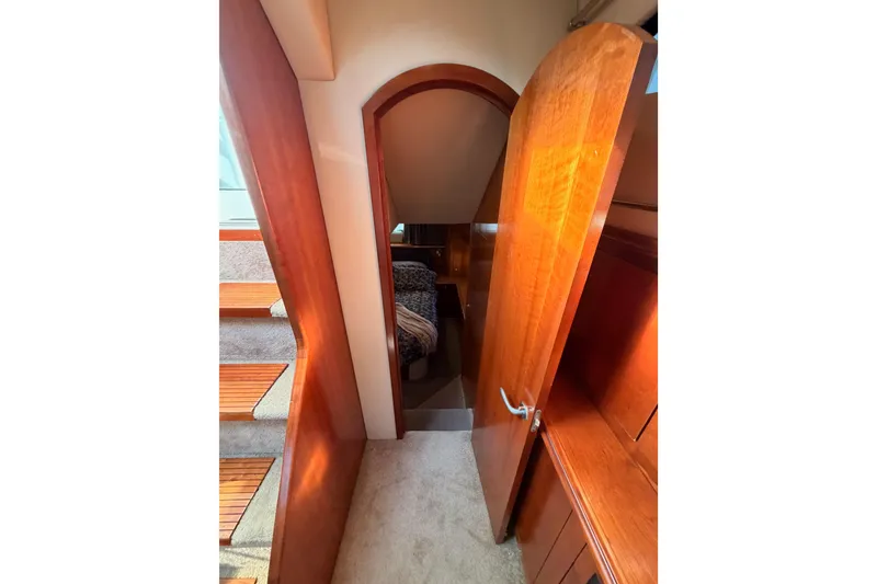 Slide: The Image of Interior view of 2005 Cruisers Yachts 405 Express Motoryacht with wooden finishes and carpeted stairs. - 74