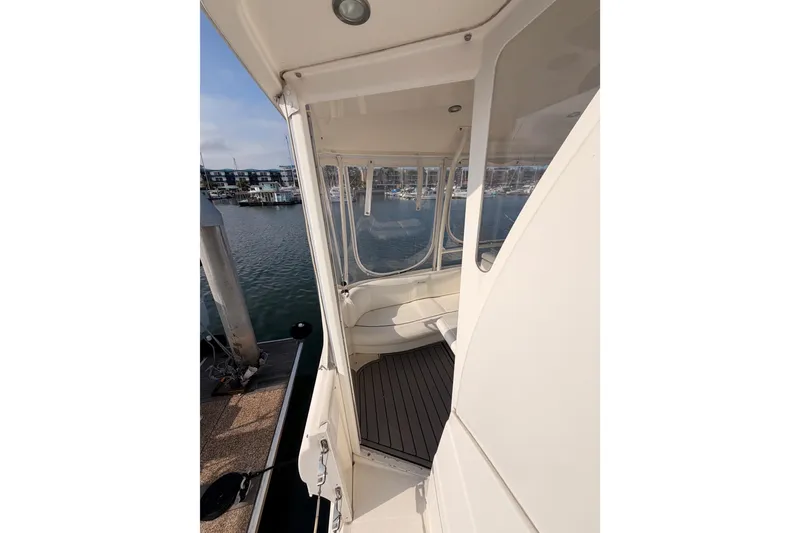 Slide: The Image of 2005 Cruisers Yachts 405 Express Motoryacht docked, showcasing exterior and marina view. - 25