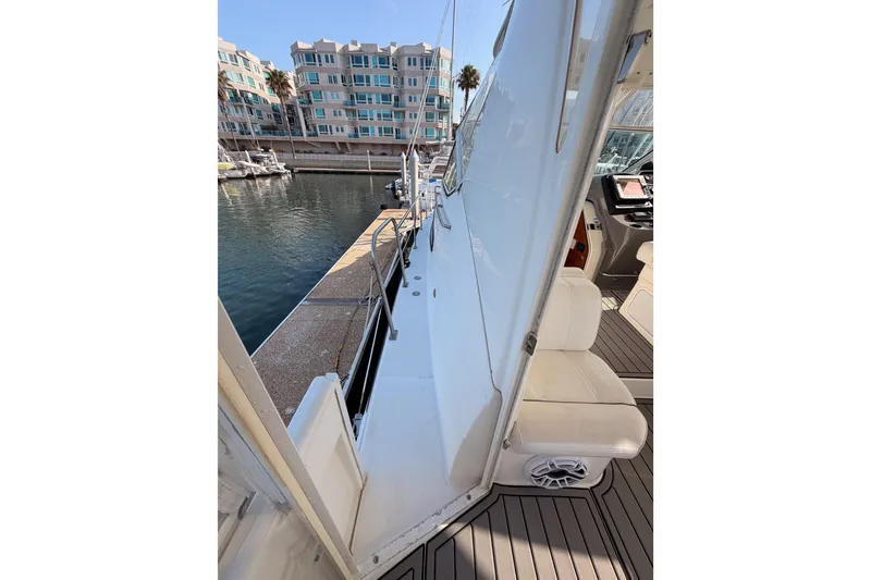 Slide: The Image of 2005 Cruisers Yachts 405 Express Motoryacht docked, showcasing sleek design and luxurious seating. - 17