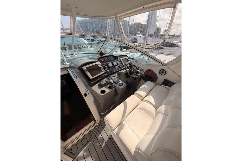 Slide: The Image of 2005 Cruisers Yachts 405 Express Motoryacht helm with modern controls and plush seating. - 32