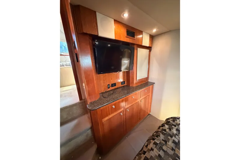 Slide: The Image of Interior of 2005 Cruisers Yachts 405 Express Motoryacht with TV and wooden cabinetry. - 80