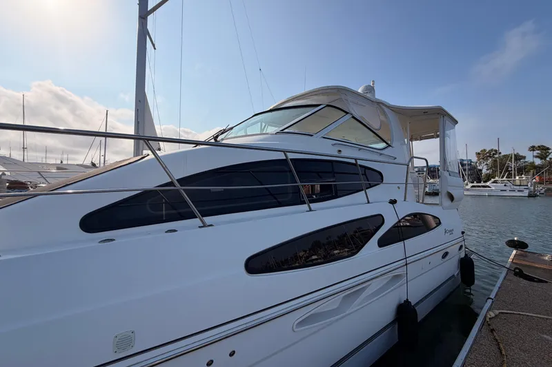 Slide: The Image of 2005 Cruisers Yachts 405 Express Motoryacht docked at marina under clear sky. - 5