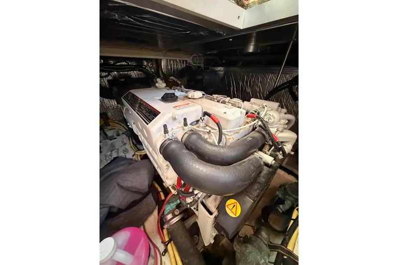 Slide: The Image of Engine compartment of a 2005 Cruisers Yachts 405 Express Motoryacht, showcasing mechanical components. - 89