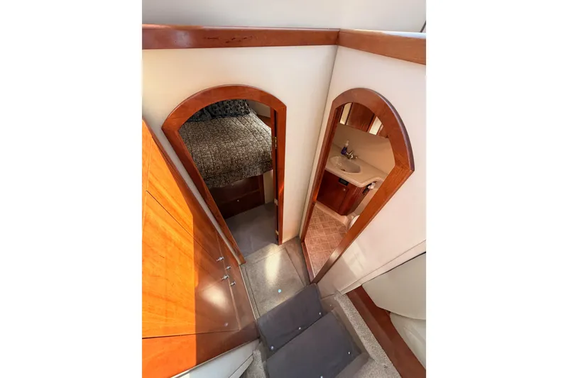 Slide: The Image of Interior view of 2005 Cruisers Yachts 405 Express Motoryacht, featuring bedroom and bathroom. - 53