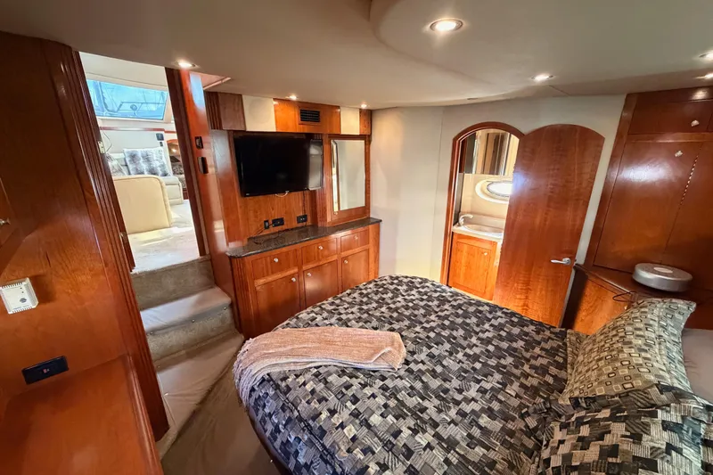 Slide: The Image of Luxurious 2005 Cruisers Yachts 405 Express Motoryacht bedroom with elegant wood finishes. - 79