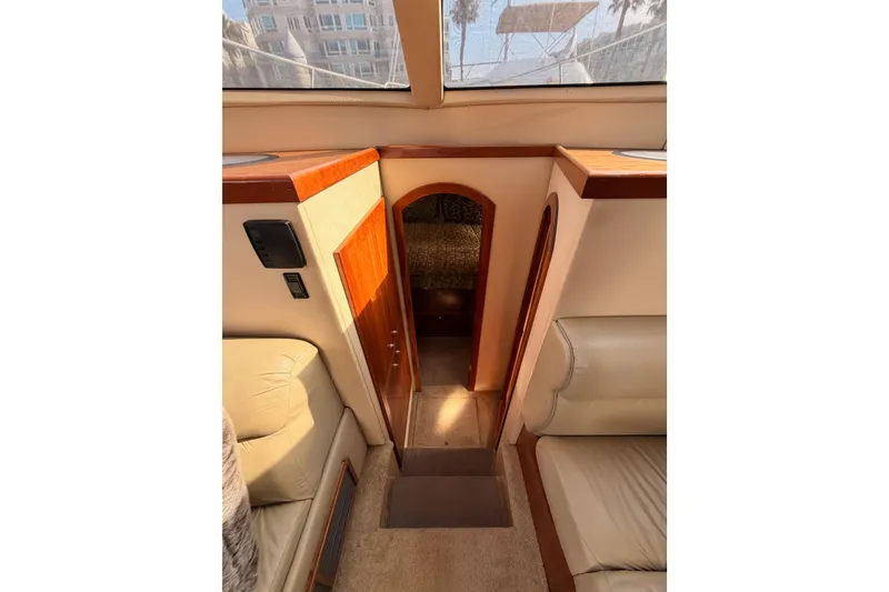 Slide: The Image of Interior view of 2005 Cruisers Yachts 405 Express Motoryacht, featuring elegant wood finishes. - 51