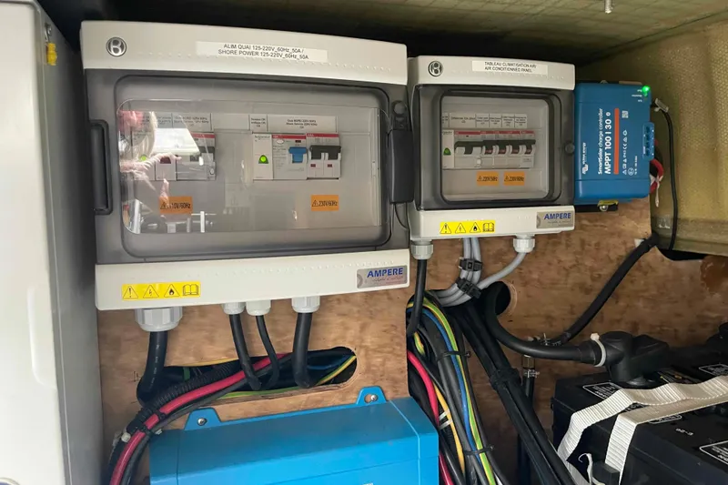 Slide: The Image of Electrical panel setup on 2022 Fountaine Pajot MY4.S yacht, featuring circuit breakers and wiring. - 58