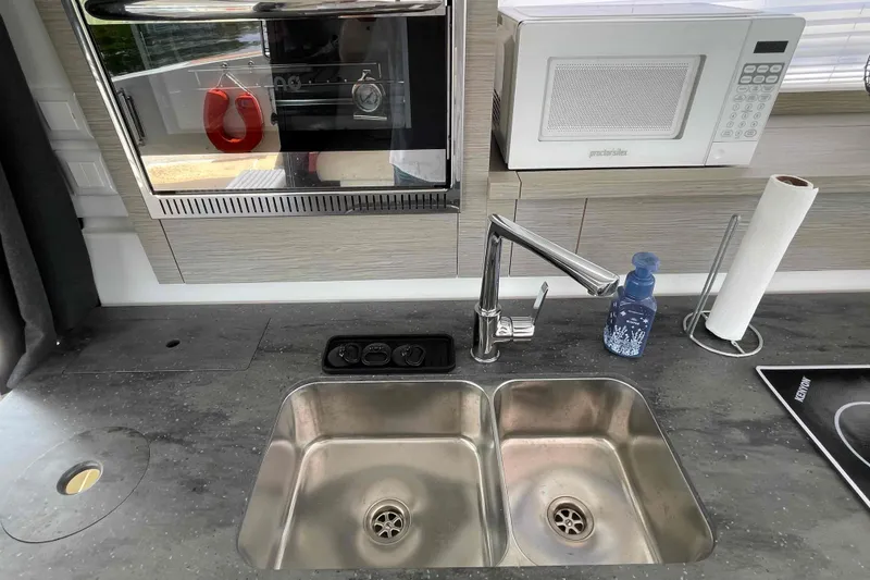 Slide: The Image of Modern kitchen in 2022 Fountaine Pajot MY4.S yacht with sink, microwave, and oven. - 12