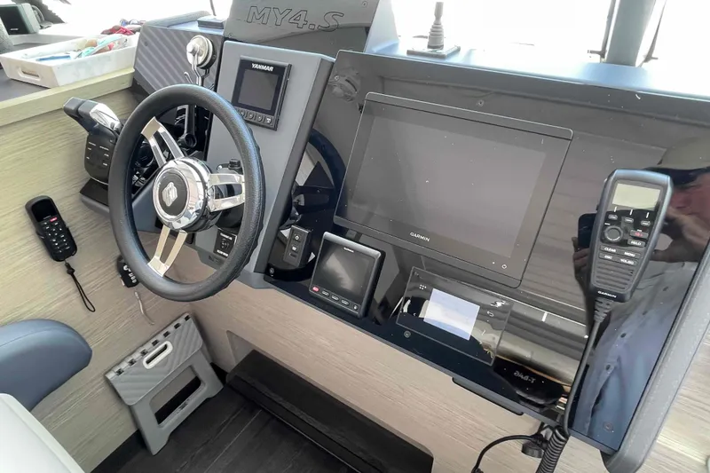 Slide: The Image of 2022 Fountaine Pajot MY4.S helm with steering wheel, Garmin display, and controls. - 42