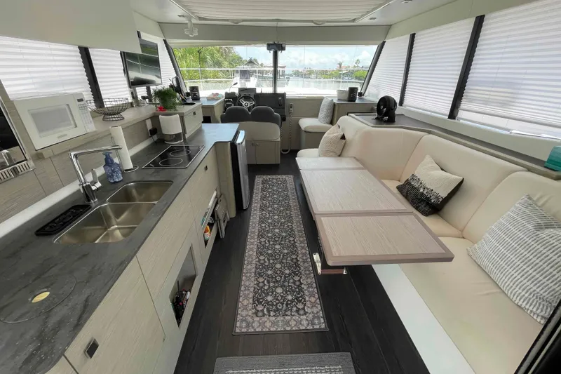 Slide: The Image of Luxurious interior of 2022 Fountaine Pajot MY4.S yacht with modern kitchen and seating area. - 39