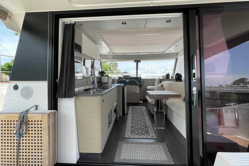 Slide: The Image of Interior view of 2022 Fountaine Pajot MY4.S yacht, featuring modern kitchen and seating area. - 15
