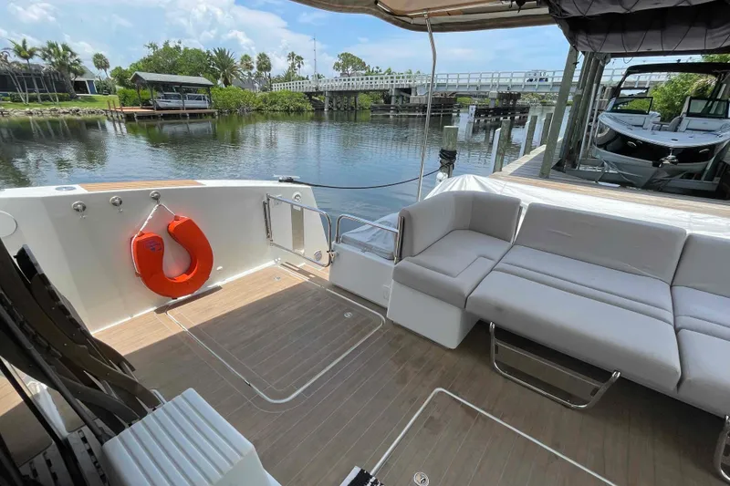 Slide: The Image of 2022 Fountaine Pajot MY4.S yacht deck with seating and waterfront view. - 48