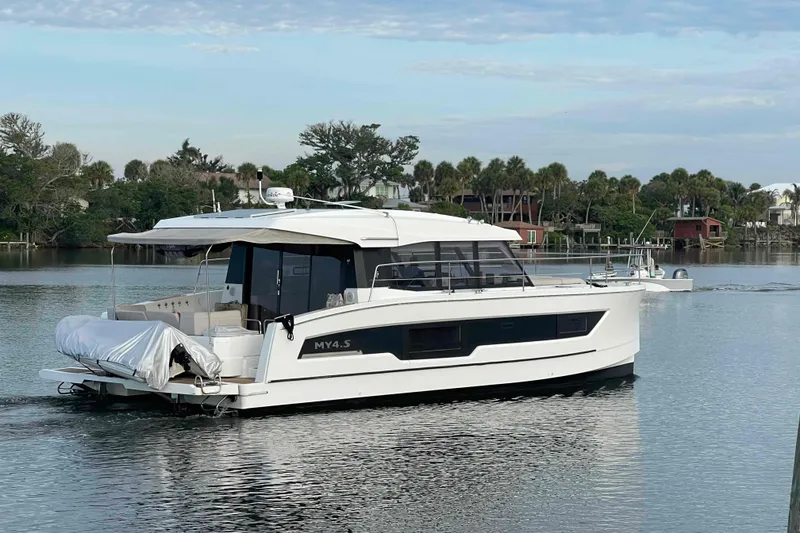 Slide: The Image of 2022 Fountaine Pajot MY4.S yacht on calm water, surrounded by lush greenery. - 68