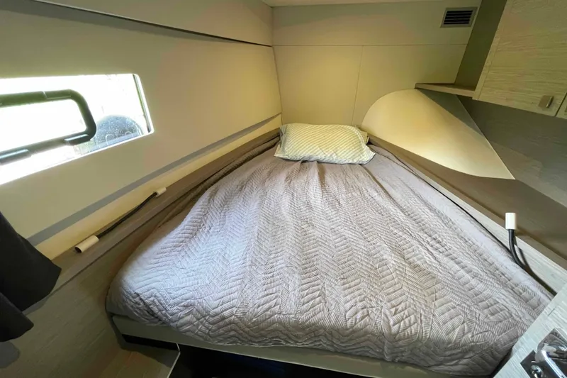 Slide: The Image of Cozy cabin interior of 2022 Fountaine Pajot MY4.S with a neatly made bed. - 27