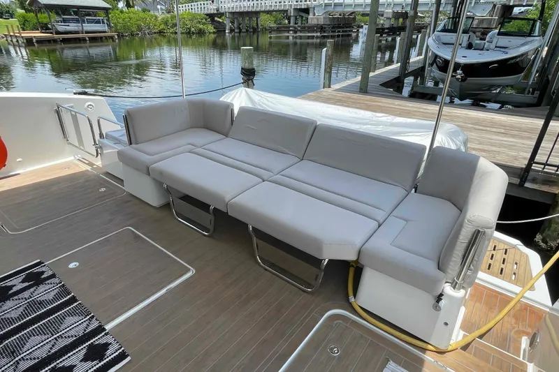 Slide: The Image of Luxurious seating area on 2022 Fountaine Pajot MY4.S yacht, docked by serene waterfront. - 46