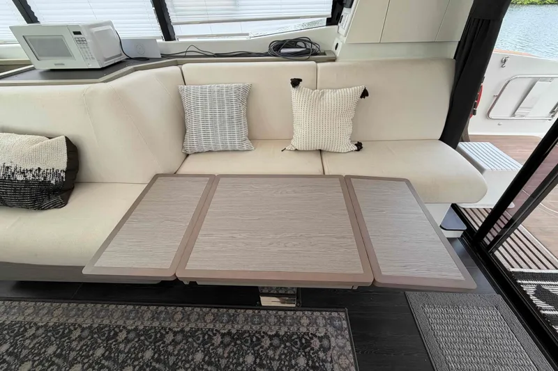 Slide: The Image of Interior of 2022 Fountaine Pajot MY4.S yacht with modern seating and table. - 11