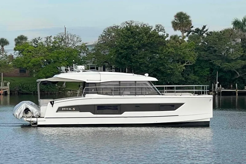 The Image of 2022 Fountaine Pajot MY4.S yacht on calm water, surrounded by lush greenery. - 0