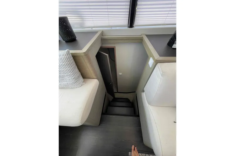 Slide: The Image of Interior stairs of 2022 Fountaine Pajot MY4.S yacht, featuring modern design and comfortable seating. - 30