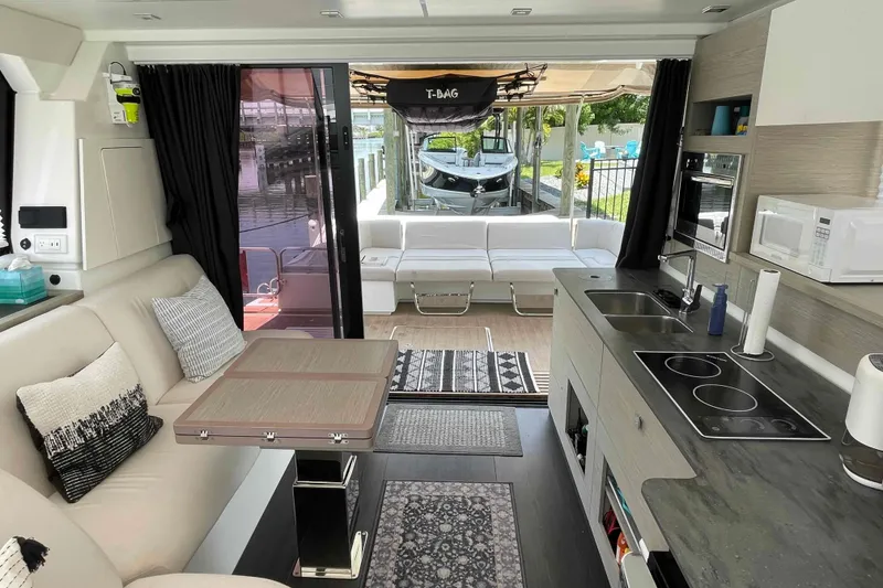 Slide: The Image of Modern interior of 2022 Fountaine Pajot MY4.S yacht with kitchen and seating area. - 6