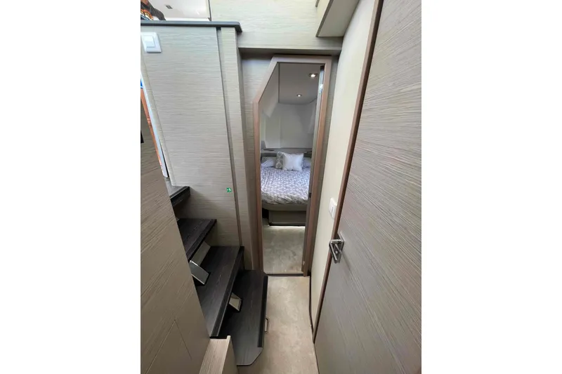 Slide: The Image of Interior view of 2022 Fountaine Pajot MY4.S yacht, featuring a cozy bedroom and staircase. - 28