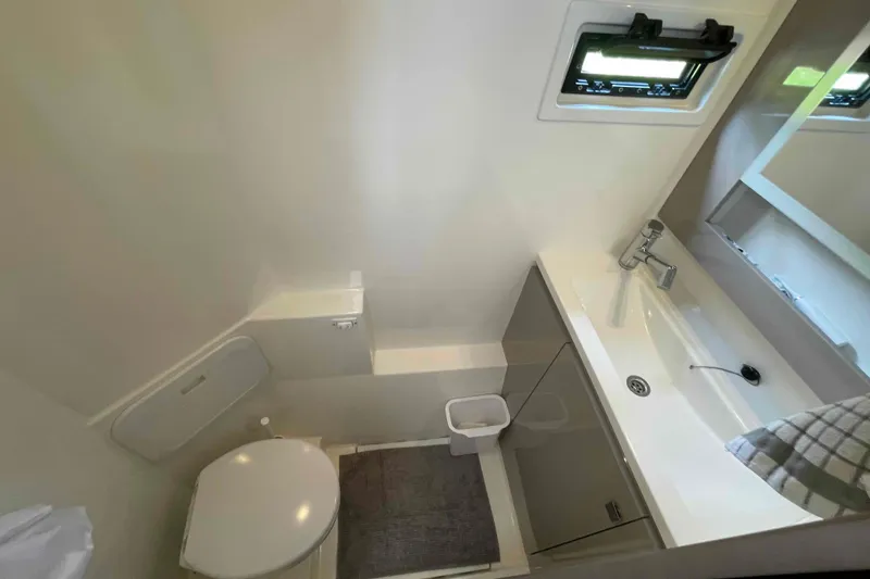 Slide: The Image of Modern bathroom interior of 2022 Fountaine Pajot MY4.S yacht, featuring sleek sink and compact toilet. - 23