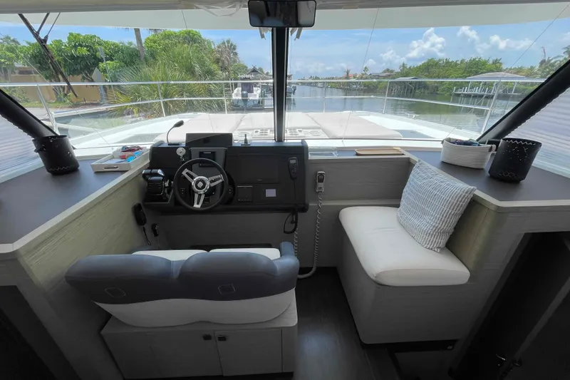 Slide: The Image of Helm station of 2022 Fountaine Pajot MY4.S yacht with modern controls and seating. - 40
