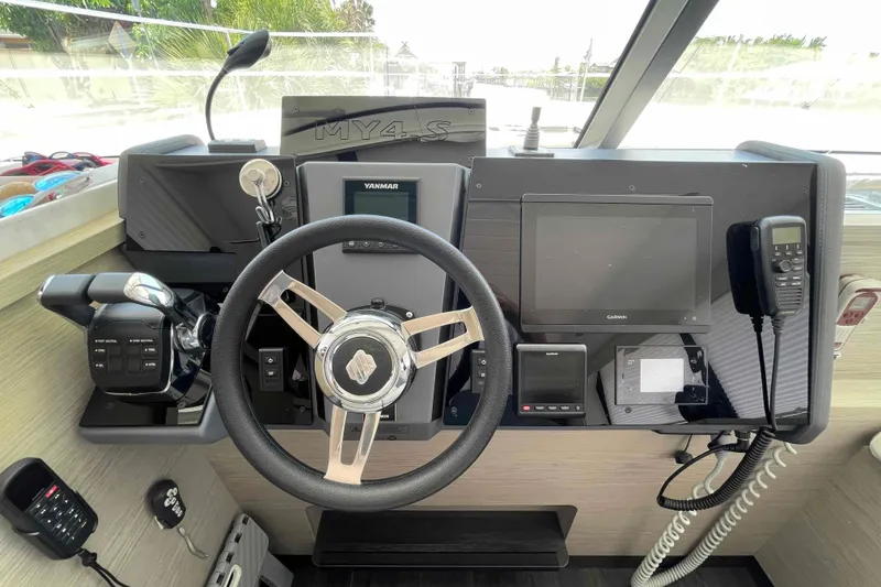 Slide: The Image of 2022 Fountaine Pajot MY4.S helm with steering wheel, controls, and navigation equipment. - 2