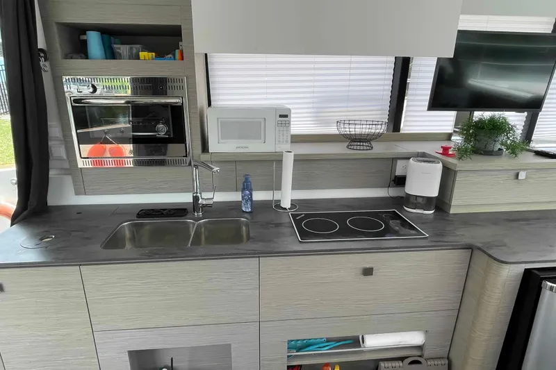 Slide: The Image of Modern kitchen in 2022 Fountaine Pajot MY4.S yacht with appliances and sleek design. - 11