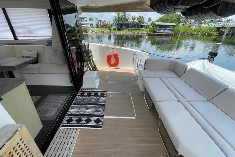 Slide: The Image of Luxurious 2022 Fountaine Pajot MY4.S yacht interior with elegant seating and scenic water view. - 4