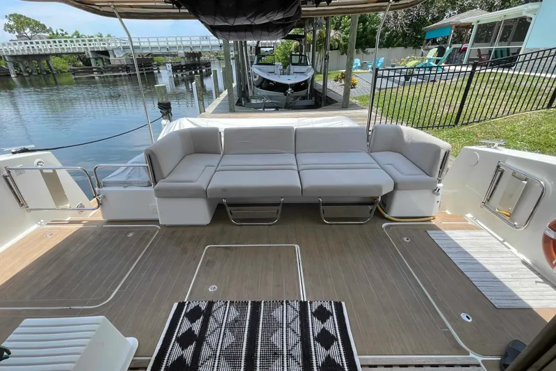 Slide: The Image of Luxury 2022 Fountaine Pajot MY4.S yacht with spacious outdoor seating and scenic waterfront view. - 47