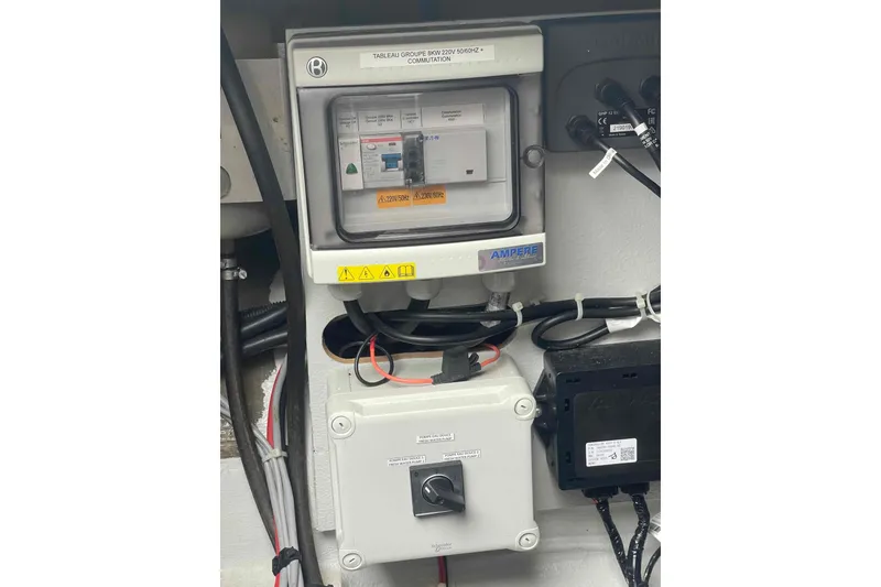 Slide: The Image of Electrical panel on a 2022 Fountaine Pajot MY4.S yacht, featuring wiring and switches. - 65