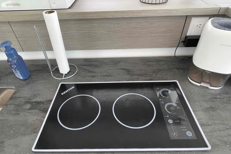 Slide: The Image of Modern kitchen countertop with Kenyon induction cooktop on Fountaine Pajot MY4.S 2022 yacht. - 13