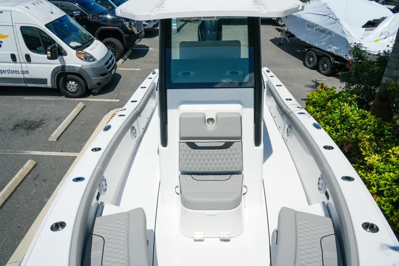 Slide: The Image of 2026 Blackfin 262 HB boat interior with sleek seating and modern design in a parking lot. - 22