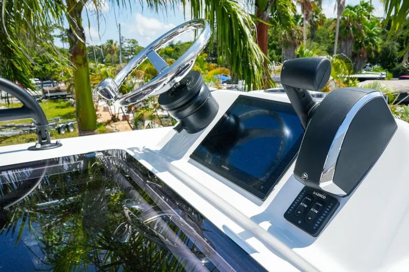 Slide: The Image of 2026 Blackfin 262 HB boat helm with steering wheel and digital display. - 24