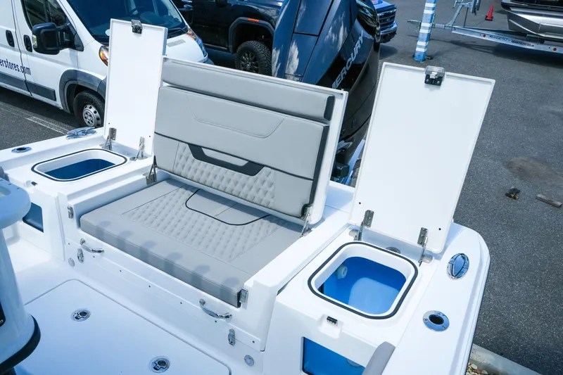 Slide: The Image of 2026 Blackfin 262 HB boat with open storage compartments and seating in a parking lot. - 36
