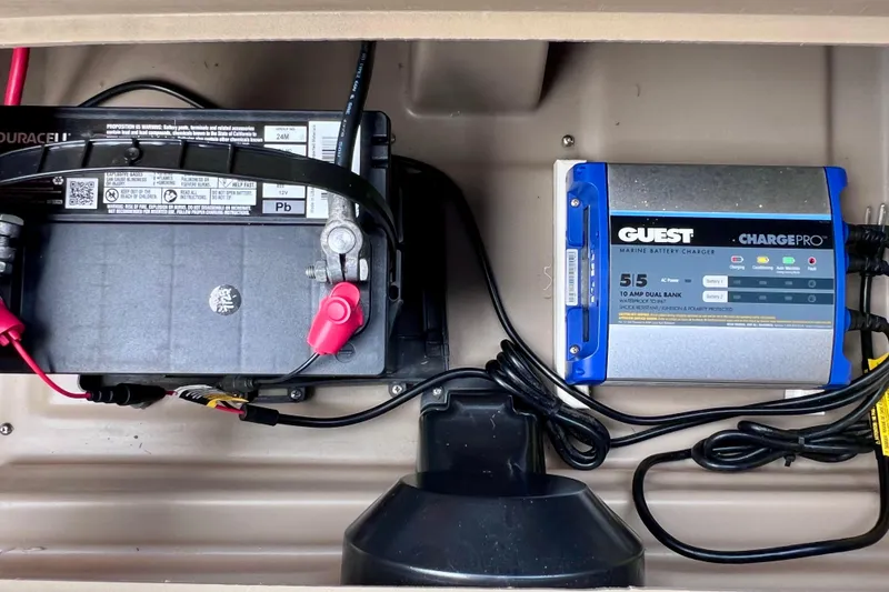Slide: The Image of Battery and marine charger setup in a 2021 Starcraft SLS 3 boat. - 22