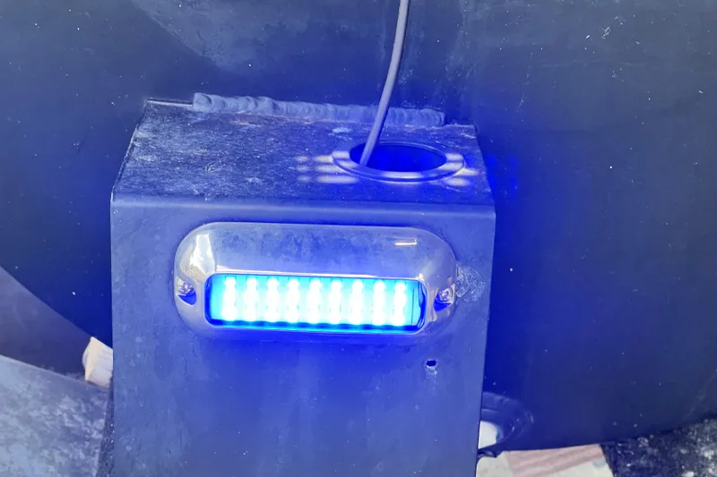 Slide: The Image of Blue LED light on 2021 Starcraft SLS 3 boat, illuminating a dark surface. - 48