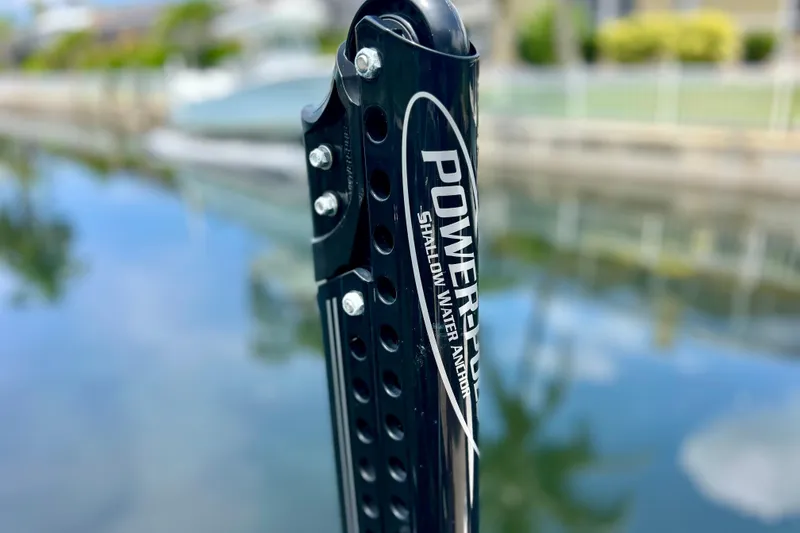 Slide: The Image of Power-Pole shallow water anchor on a Starcraft SLS 3, 2021 model, near a calm waterway. - 13